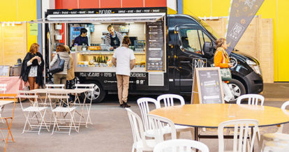 Customers interacting with employees inside a food truck