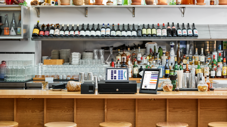 TouchBistro hardware displayed on a restaurant countertop.