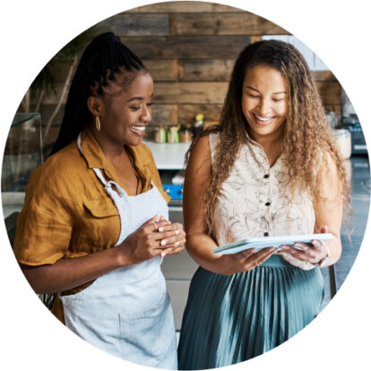 Two girls smiling at a checklist